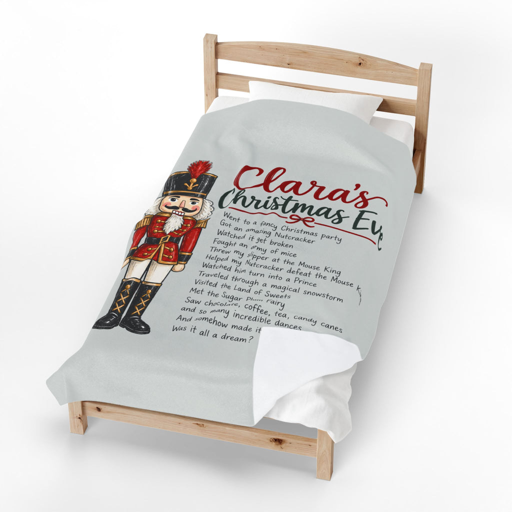 A personalized Christmas duvet cover featuring a nutcracker illustration and the text 'Clara's Christmas Eve' with a poem, shown on a light gray single bed frame against a white background.
