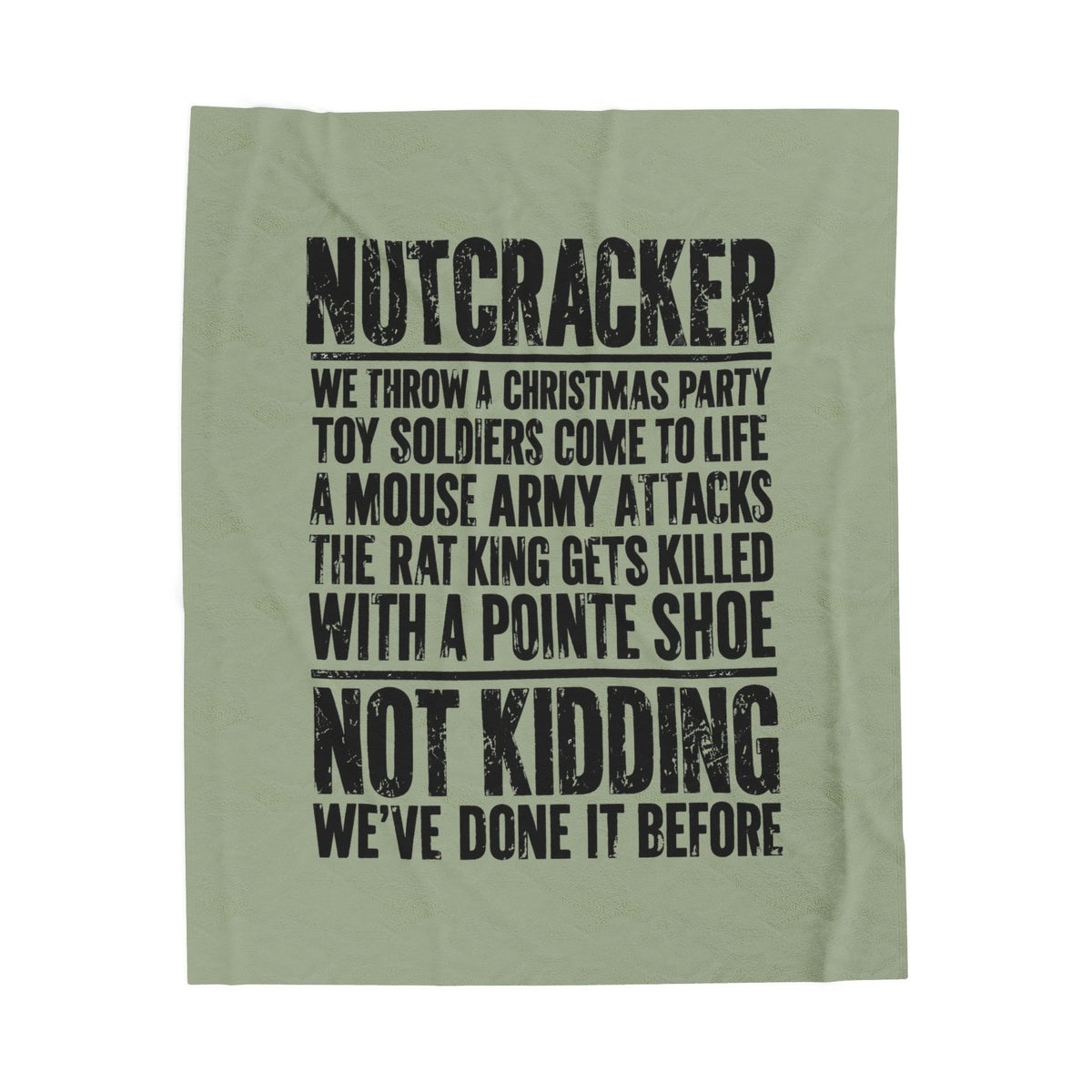 An olive green fabric item, likely a towel or blanket, featuring a black distressed text print about a Christmas toy soldier prank.