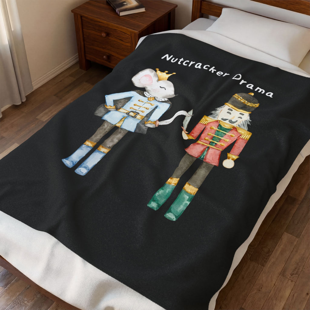 Black blanket with Nutcracker-themed design on a bed