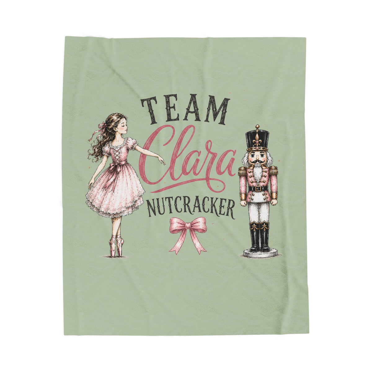 A sage green blanket featuring a custom printed design with the text 'TEAM Clara NUTCRACKER' in black and pink script, accompanied by illustrations of a ballerina girl in a pink dress and a nutcracker.