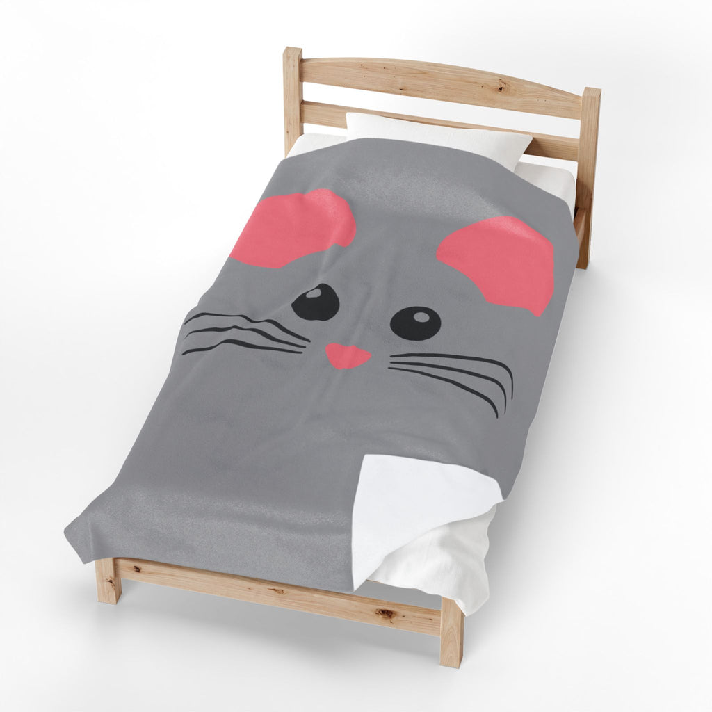 A gray comforter featuring a cartoon mouse face with pink ears and nose, black eyes, and whiskers, styled on a wooden toddler bed against a white background.