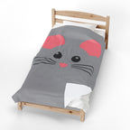 A gray comforter featuring a cartoon mouse face with pink ears and nose, black eyes, and whiskers, styled on a wooden toddler bed against a white background.
