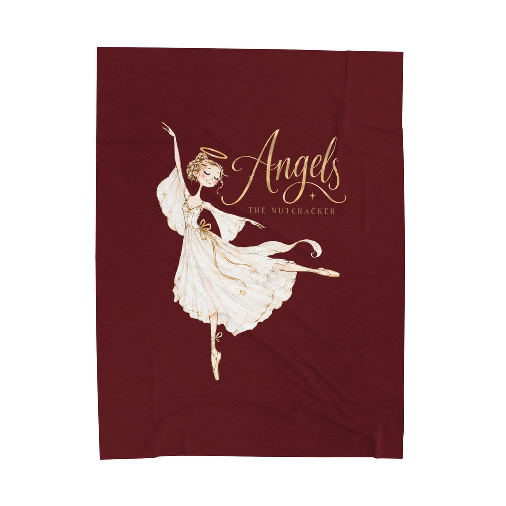 A rectangular dark burgundy fabric item, likely a towel or blanket, featuring a gold and white illustration of a ballerina angel with the text 'Angels The Nutcracker'.