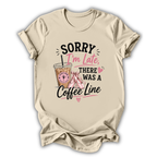 Beige t-shirt with a coffee-themed graphic and text on a white background