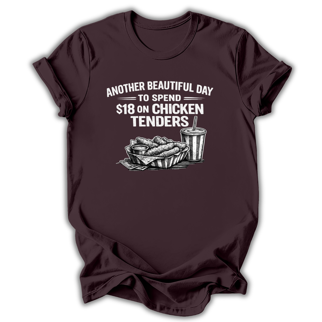 Brown t-shirt with graphic of chicken tenders and a drink, text 'Another Beautiful Day to Spend $18 on Chicken Tenders' on a white background.
