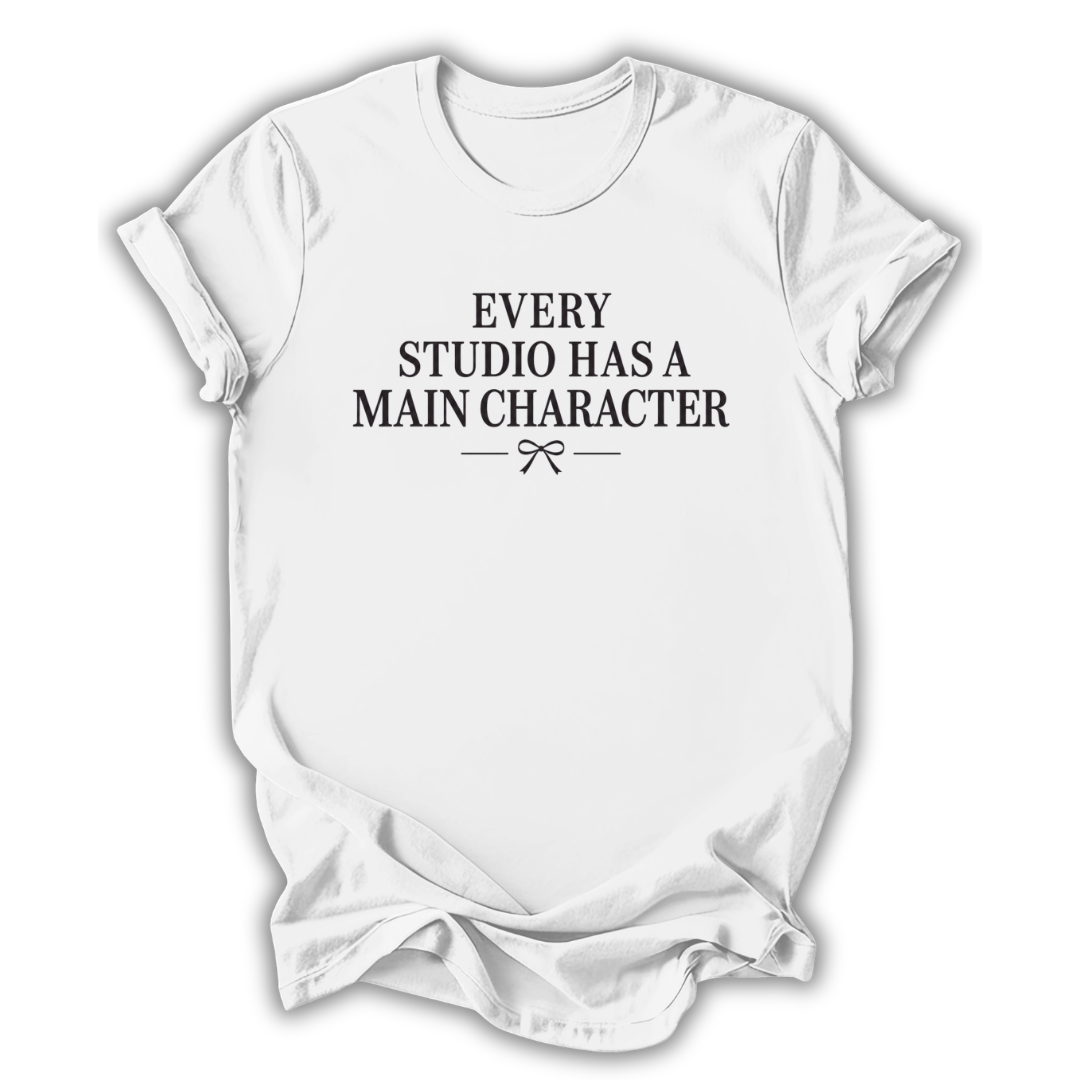 White t-shirt with black text 'Every Studio Has a Main Character' on a white background