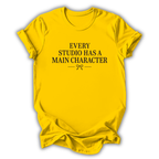 Yellow t-shirt with black text 'Every Studio Has a Main Character' on a white background