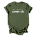 Green t-shirt with text 'I'm not yelling I'm projecting' on a white background