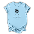 Light blue t-shirt with a graphic of a bun and text on a white background