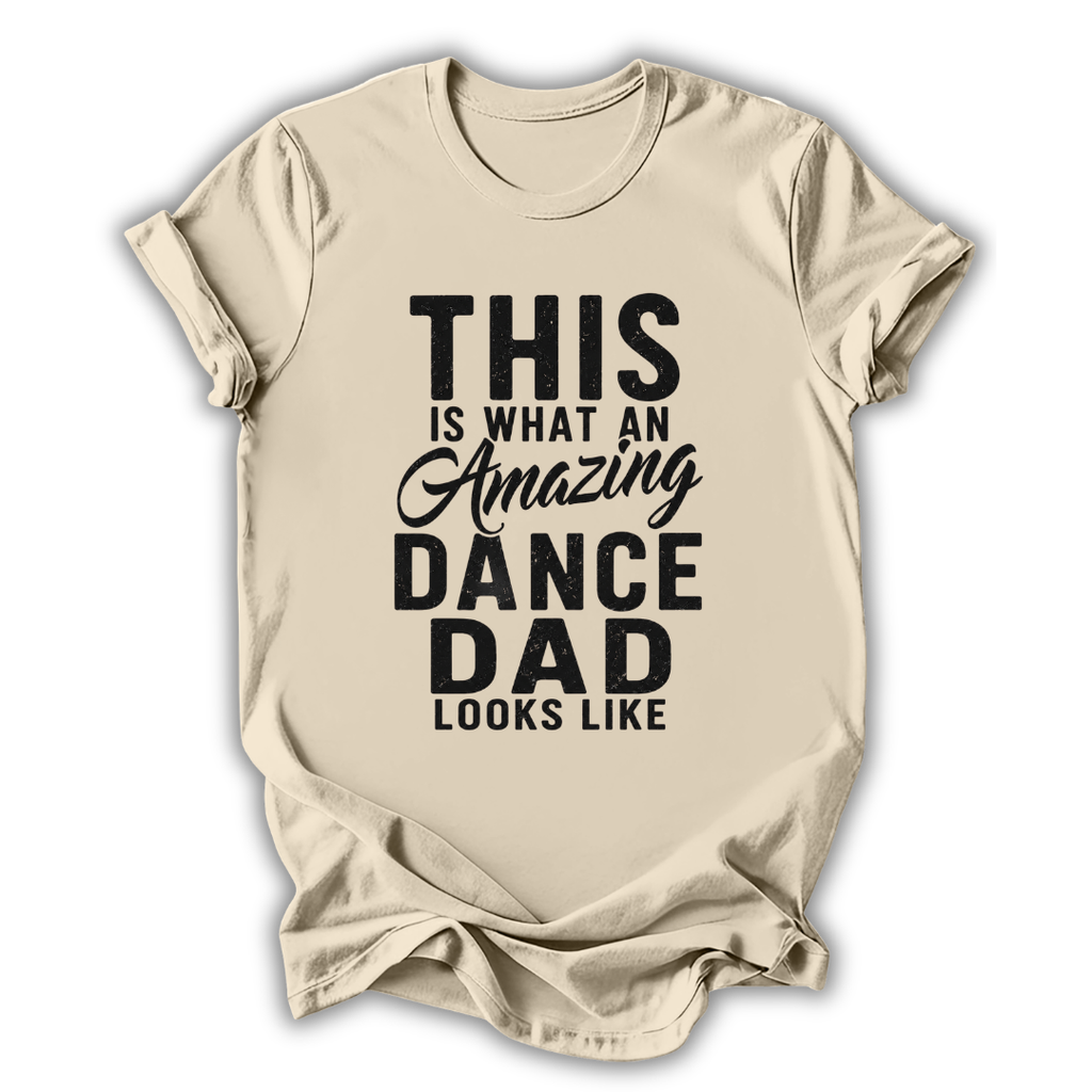 Beige t-shirt with black text 'This is what an amazing dance dad looks like' on a white background