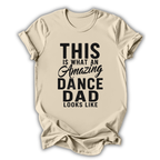 Beige t-shirt with black text 'This is what an amazing dance dad looks like' on a white background