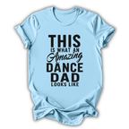 Light blue t-shirt with black text 'This is what an amazing dance dad looks like' on a white background
