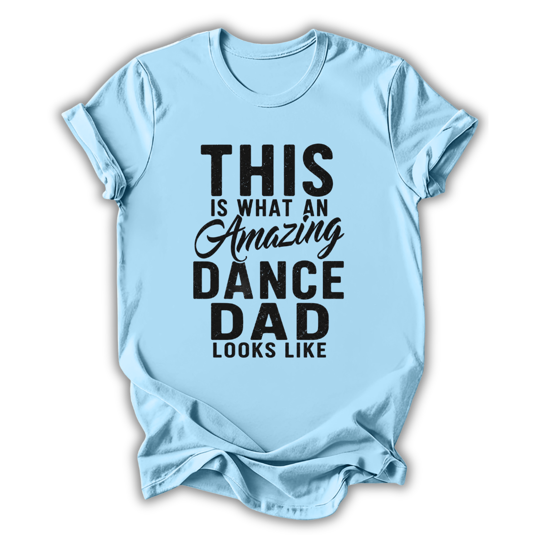 Light blue t-shirt with black text 'This is what an amazing dance dad looks like' on a white background