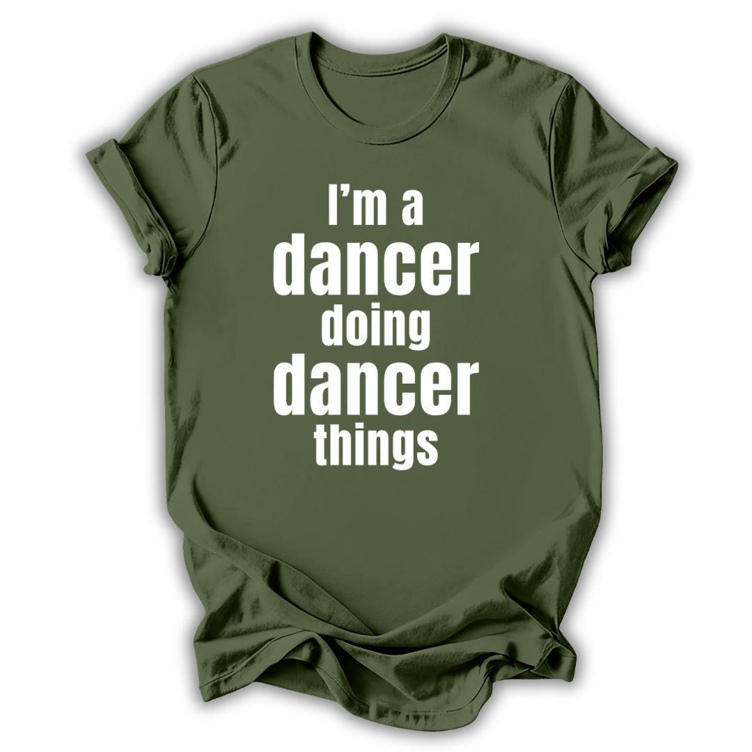 Green t-shirt with white text 'I'm a dancer doing dancer things' on a white background