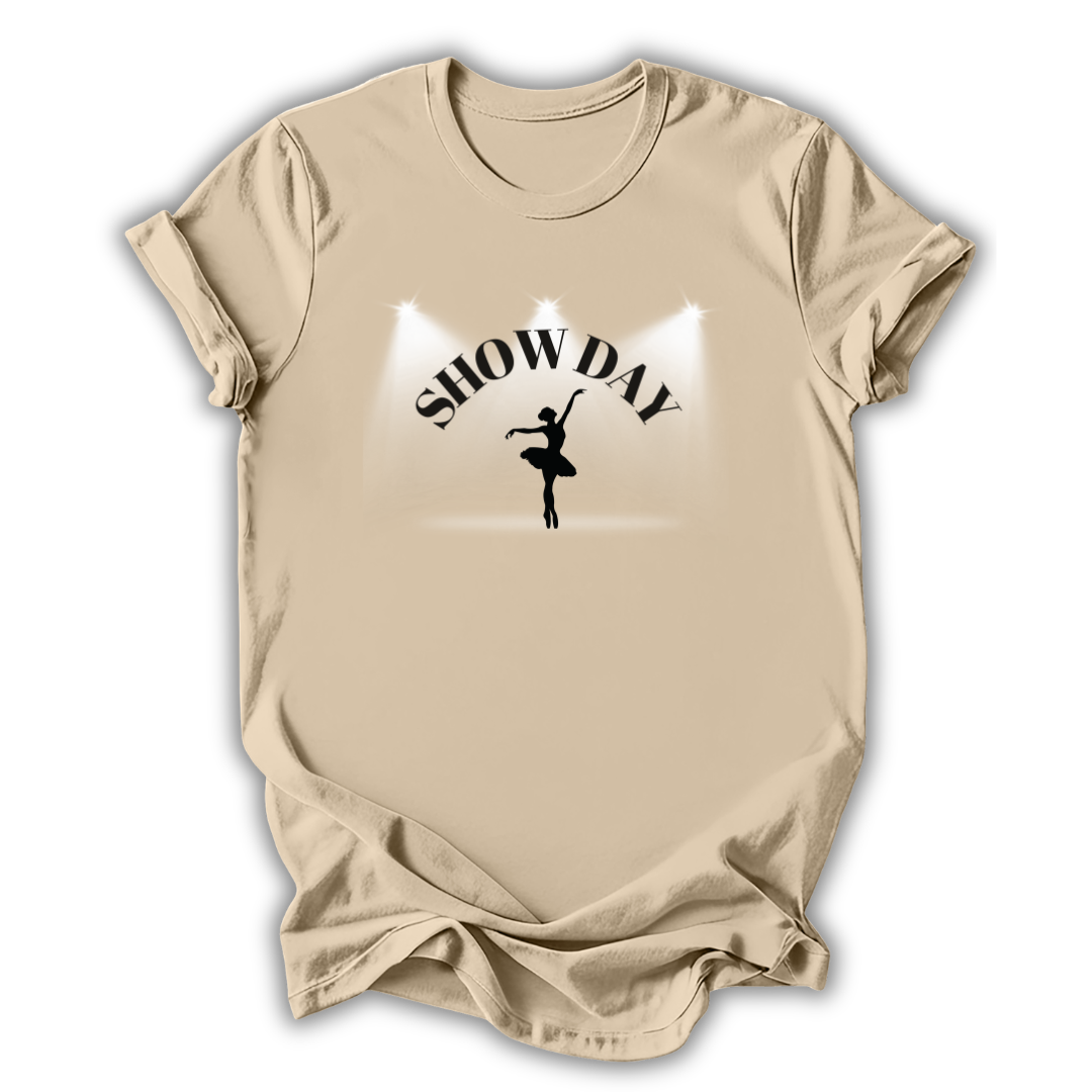 Beige t-shirt with 'SHOW DAY' and a dancer graphic on a white background