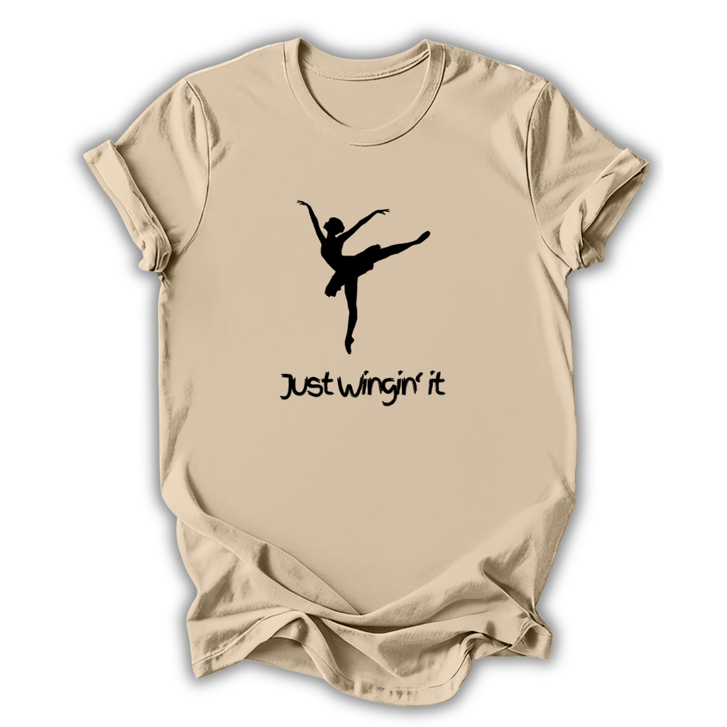 Beige t-shirt with a black silhouette of a dancer and 'Just Wingin' it' text on a white background