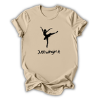 Beige t-shirt with a black silhouette of a dancer and 'Just Wingin' it' text on a white background
