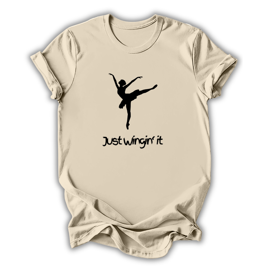 Beige t-shirt with a black silhouette of a dancer and 'Just Wingin' it' text on a white background