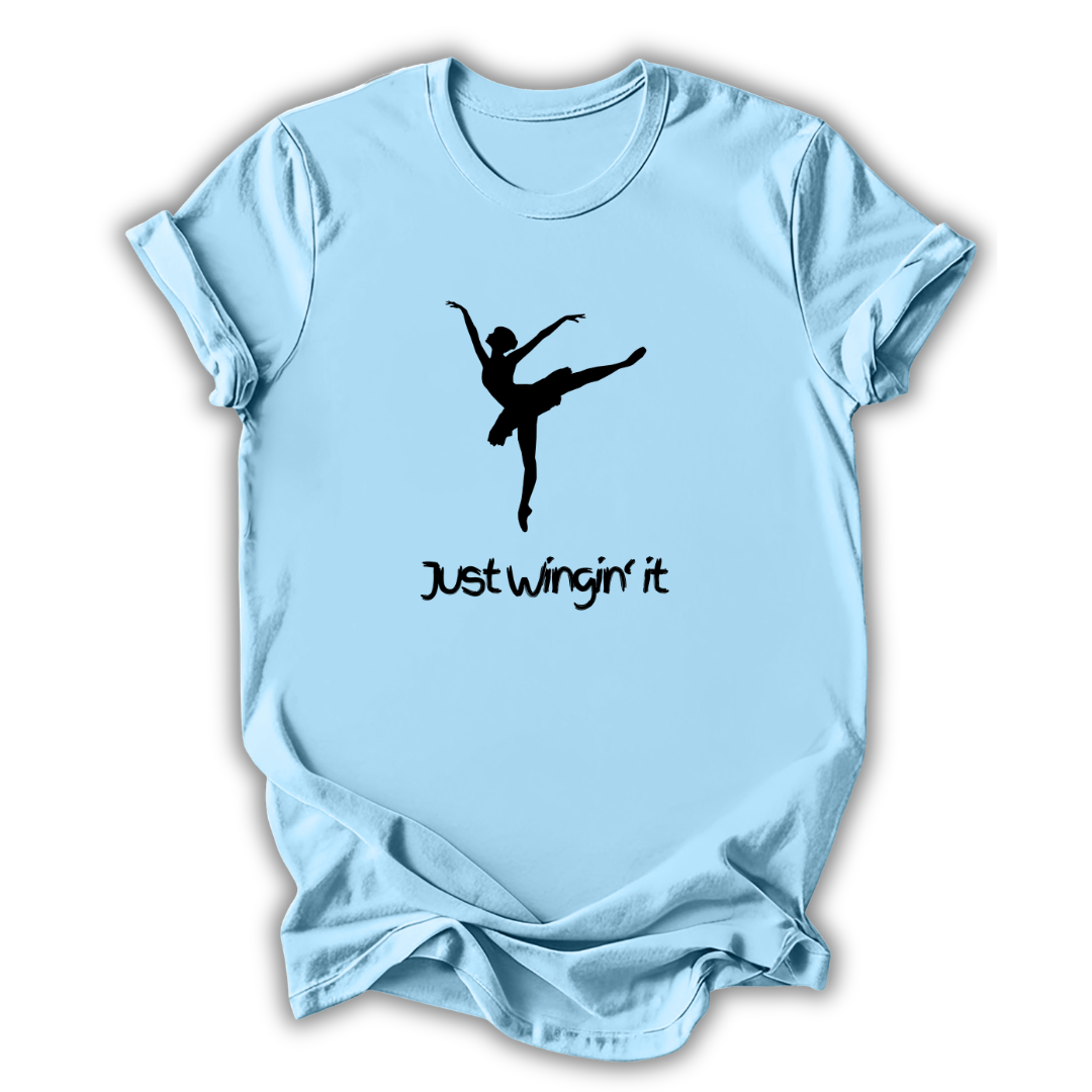 Light blue t-shirt with a black silhouette of a dancer and text 'Just wingin' it' on a white background