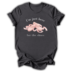 Black t-shirt with pink shoes graphic and text on a white background