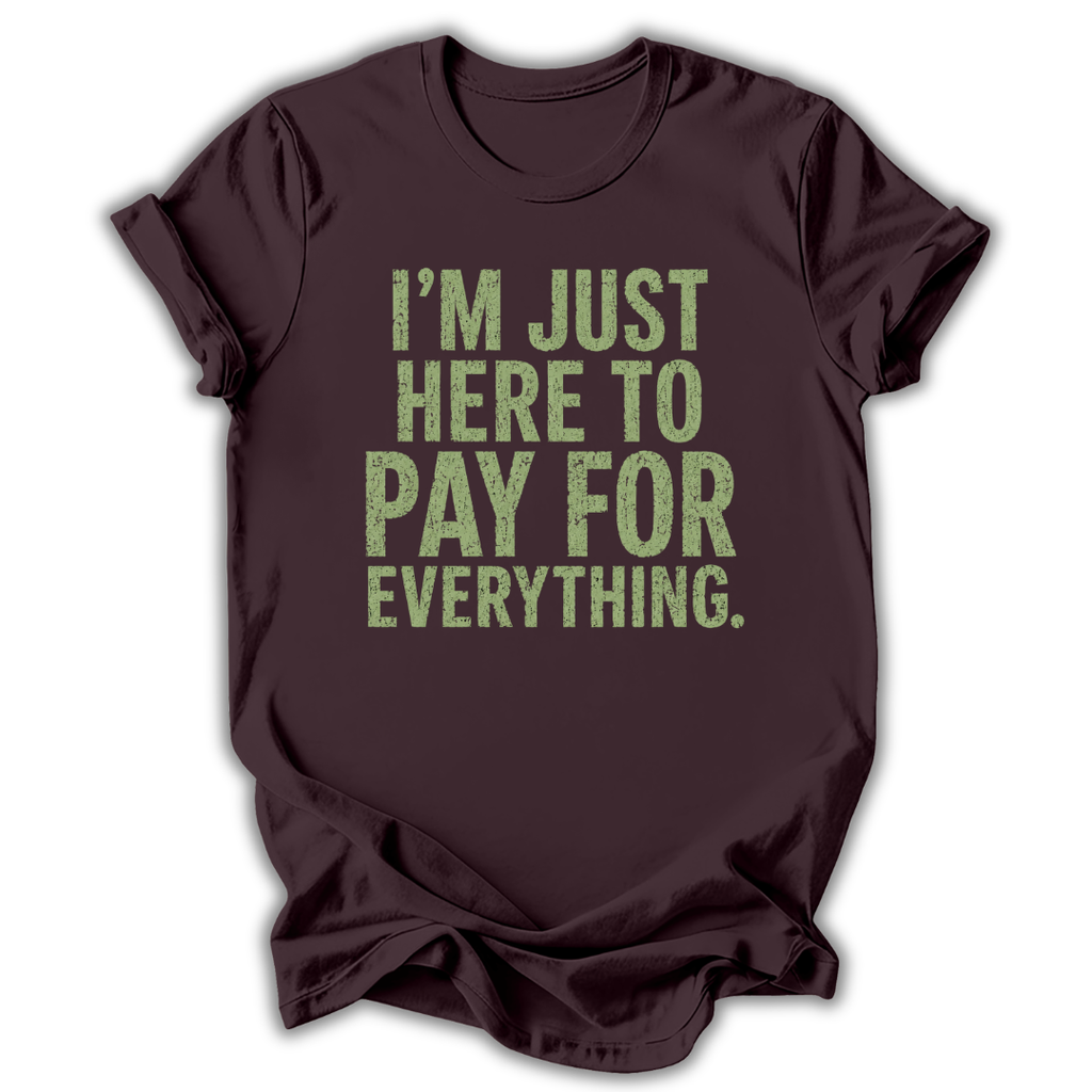 Brown t-shirt with green text 'I'm just here to pay for everything' on a white background