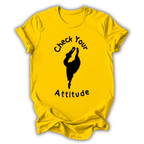 Yellow t-shirt with black graphic and text 'Check Your Attitude' on a white background