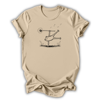 Beige t-shirt with a graphic design of a person balancing on a seesaw.