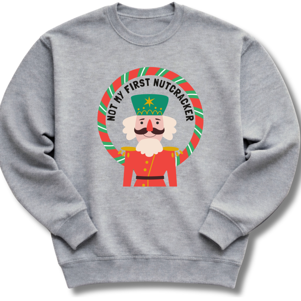 Gray sweatshirt with a Christmas-themed graphic of a nutcracker and text on a white background