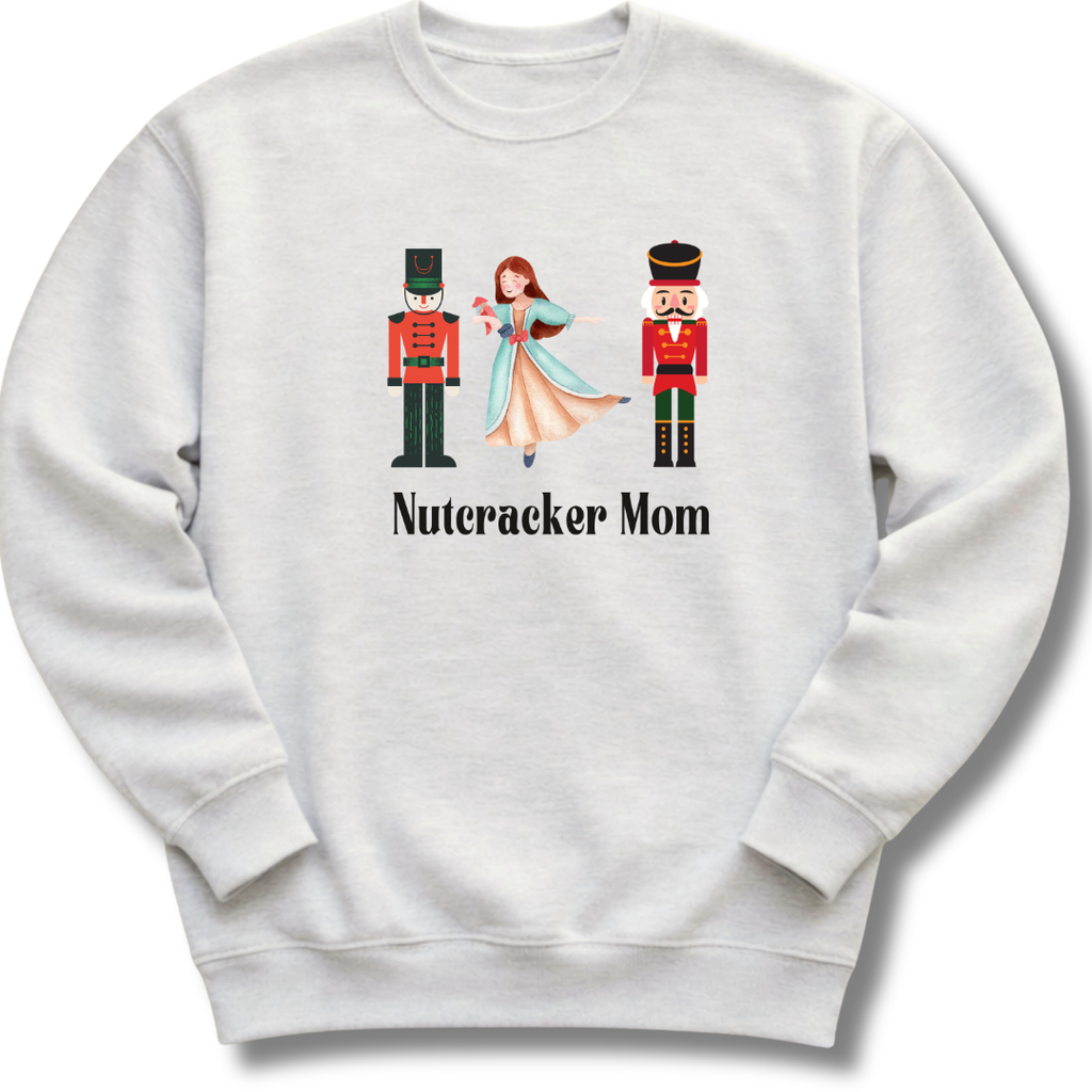 White sweatshirt with 'Nutcracker Mom' design featuring two nutcrackers and a ballerina on a white background.
