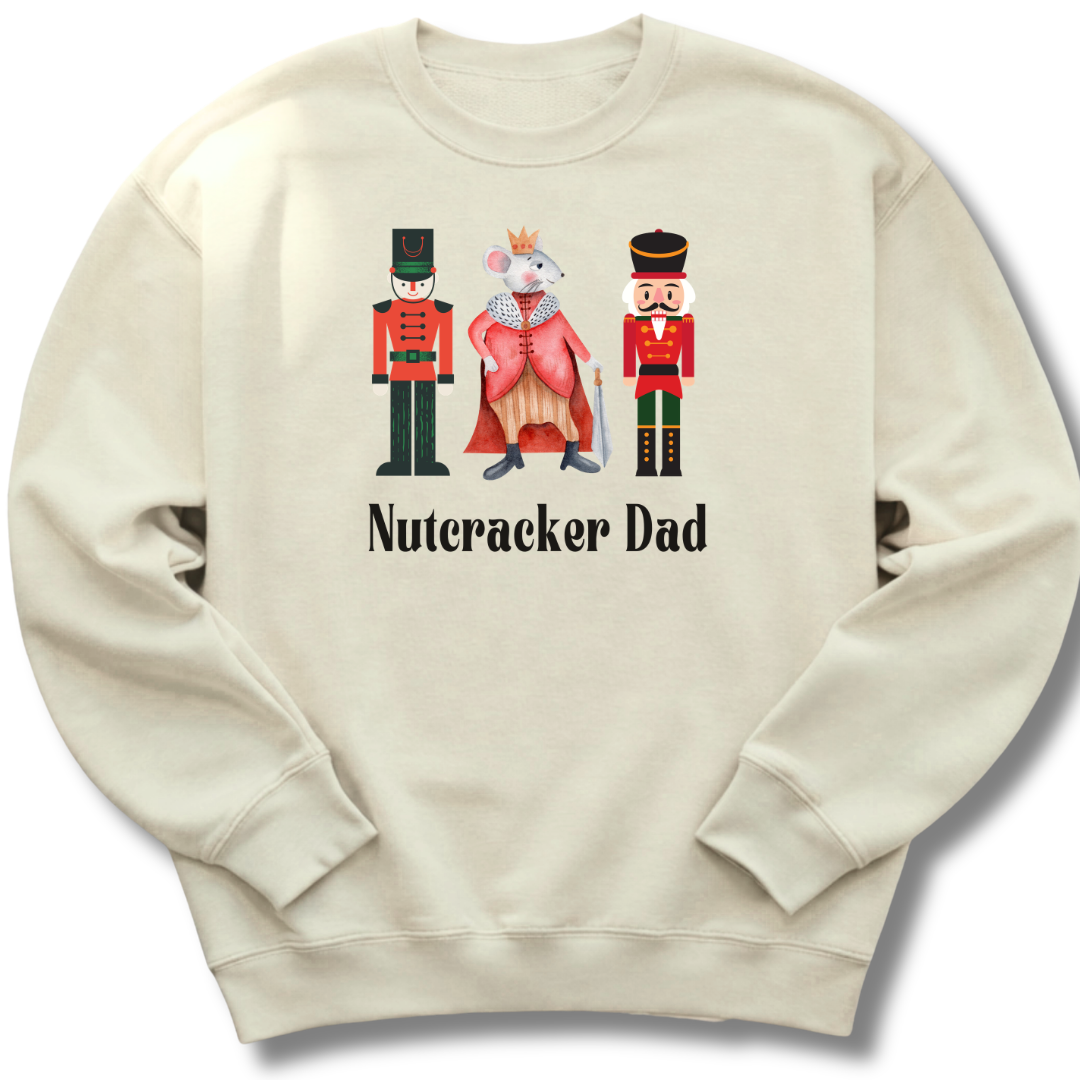 Beige sweatshirt with Nutcracker-themed design and 'Nutcracker Dad' text on a white background