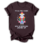 A dark brown short-sleeve t-shirt with a graphic of a cartoon mouse dressed as a king in a red robe and blue pants, surrounded by white text that reads 'IT'S ALL FUN & GAMES UNTIL THE MOUSE KING SHOWS UP' on a white background.