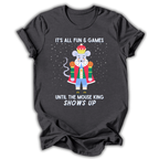 A dark brown short-sleeve t-shirt with a graphic of a cartoon mouse dressed as a king in a red robe and blue pants, surrounded by white text that reads 'IT'S ALL FUN & GAMES UNTIL THE MOUSE KING SHOWS UP' on a white background.