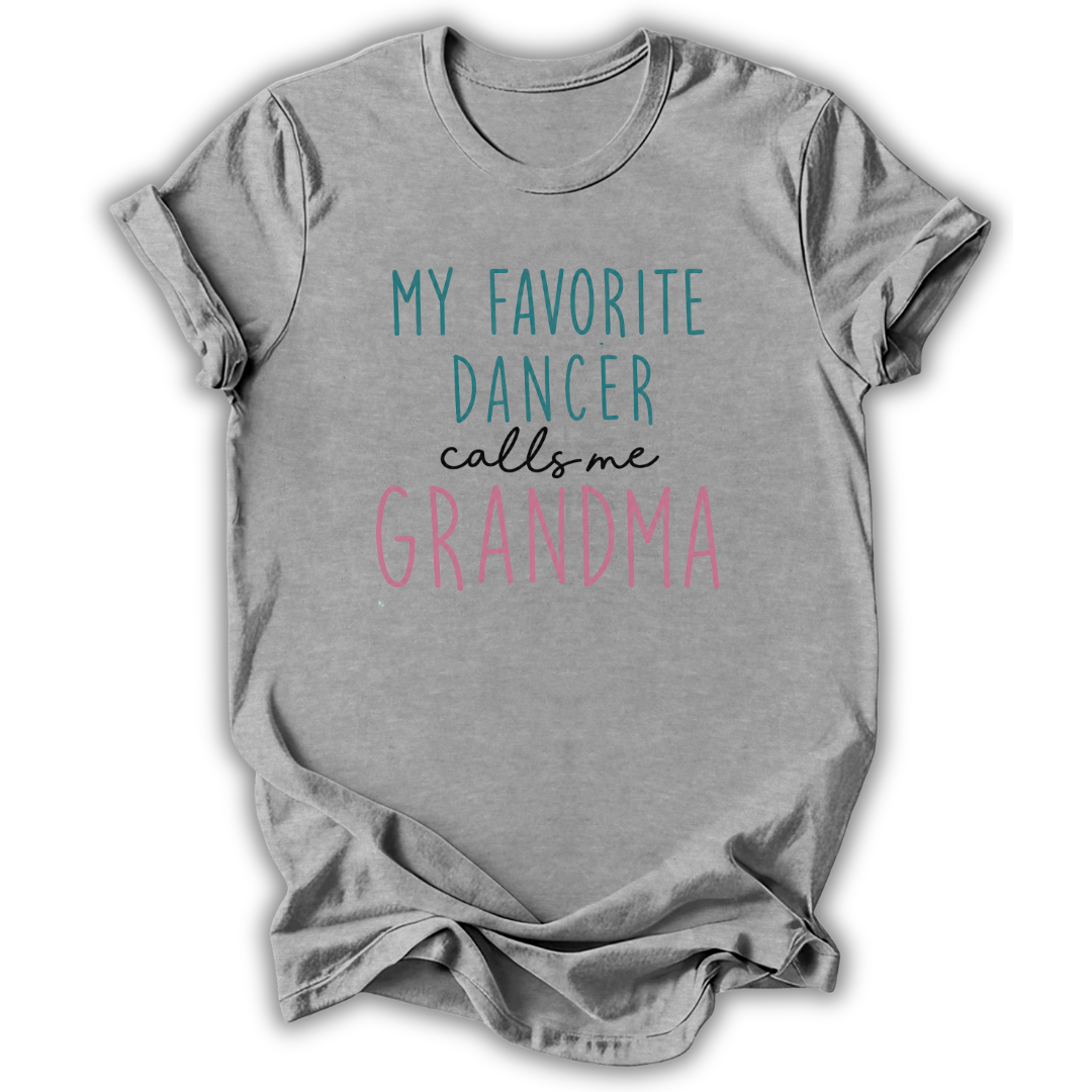 A heather gray short-sleeve t-shirt with a graphic text print reading 'MY FAVORITE DANCER calls me GRANDMA' in teal, black, and pink lettering, displayed on a clean white background.
