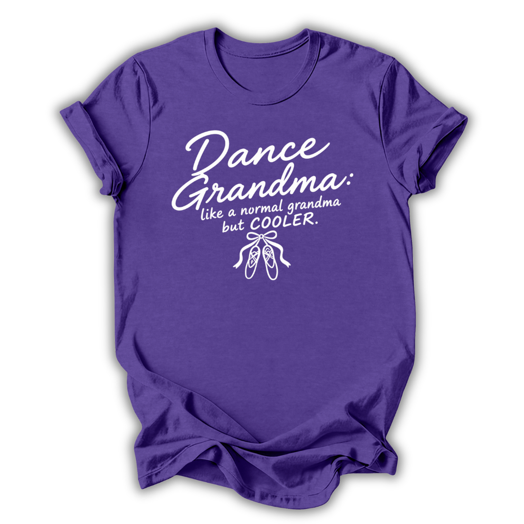A purple short-sleeve crewneck t-shirt with a white graphic print that reads 'Dance Grandma: like a normal grandma but COOLER.' above a small ballet shoe illustration, shown on a plain white background.