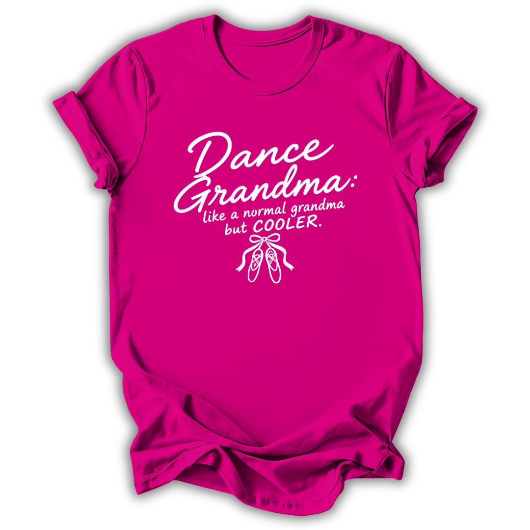 A bright pink short-sleeve t-shirt with a white graphic print that reads 'Dance Grandma: like a normal grandma but COOLER.' with a small ballet shoe illustration, shown on a plain white background.