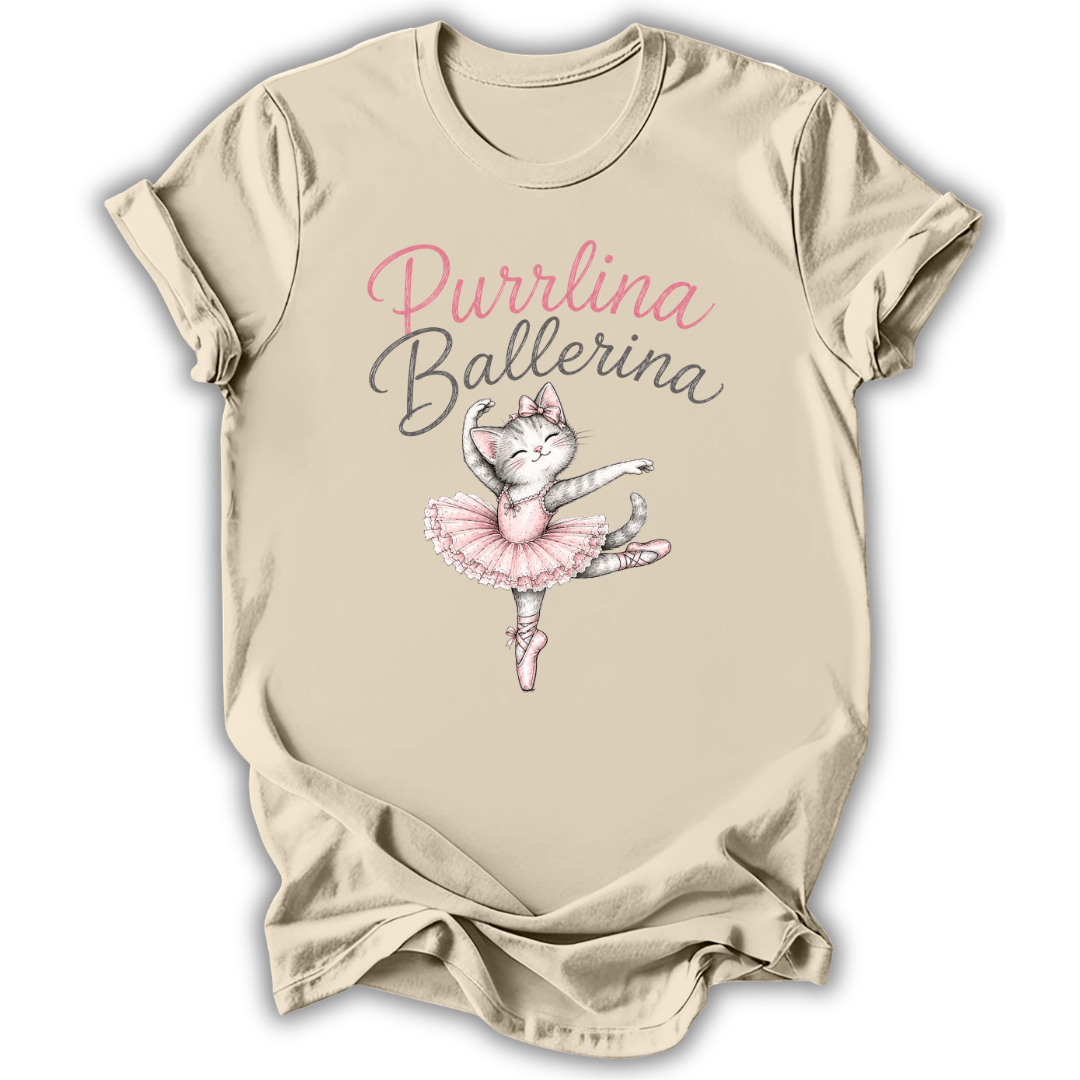 A beige short-sleeve t-shirt with a 'Purrlina Ballerina' graphic featuring a cartoon cat ballerina in a pink tutu, displayed on a clean white background.