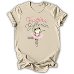 A beige short-sleeve t-shirt with a graphic print of a green frog ballerina wearing a pink tutu, with the text 'Frogina Ballerina' in pink and gray script above it.