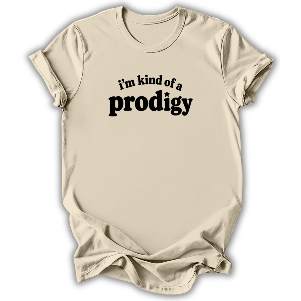 A light beige crewneck t-shirt with a black graphic text print reading 'i'm kind of a prodigy' on the chest, displayed against a clean white background.
