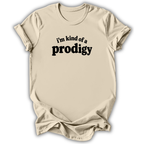 A light beige crewneck t-shirt with a black graphic text print reading 'i'm kind of a prodigy' on the chest, displayed against a clean white background.