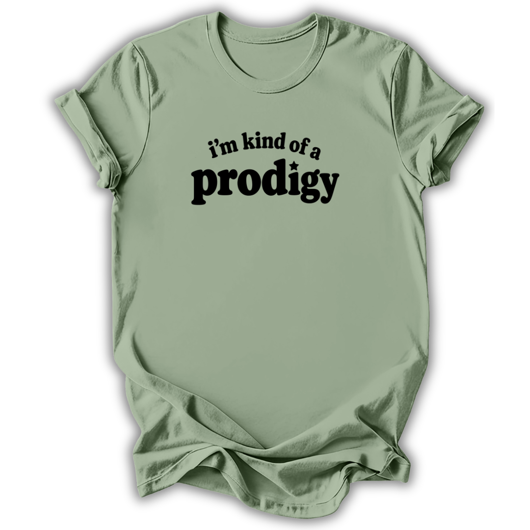 A sage green short-sleeve t-shirt with the phrase 'i'm kind of a prodigy' printed in black across the chest, displayed against a clean white background.