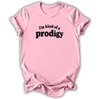 A light pink short-sleeve crewneck t-shirt with the phrase 'i'm kind of a prodigy' printed in black across the chest, displayed on a clean white background.
