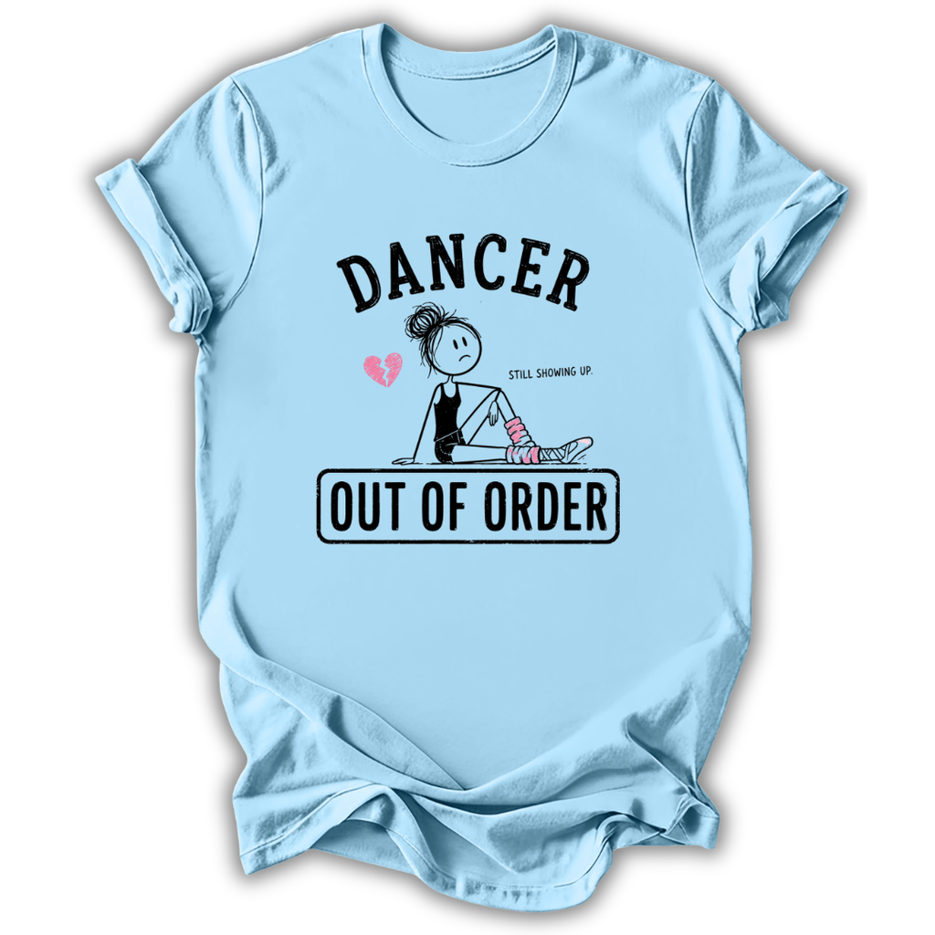 A light blue short-sleeve t-shirt with a graphic print on the front. The graphic features the word 'DANCER' in arched black letters above a stick-figure style dancer sitting with a broken heart and the phrase 'STILL MOVING UP' next to her.