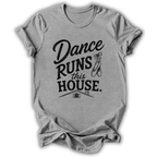A heather gray short-sleeve t-shirt with a black graphic print that reads 'Dance Runs This House.' accompanied by ballet shoes and a small house illustration, shown on a plain white background.
