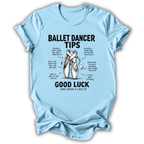 A light blue short-sleeve crewneck t-shirt with a black graphic print detailing 'Ballet Dancer Tips' and a central illustration of crossed pointe shoes, displayed on a clean white background.