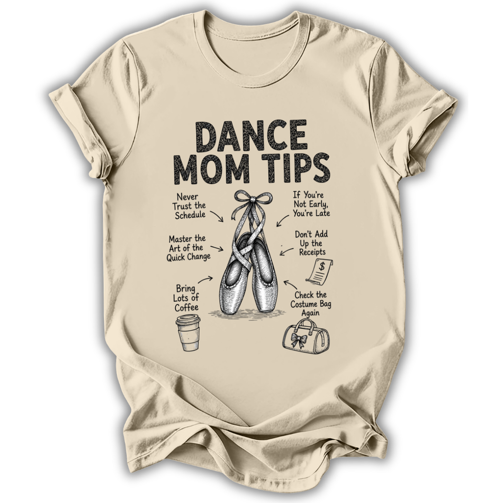 A beige short-sleeve crewneck t-shirt with a black graphic print titled 'DANCE MOM TIPS' featuring illustrations of ballet slippers and dance-related advice, shown on a plain white background.
