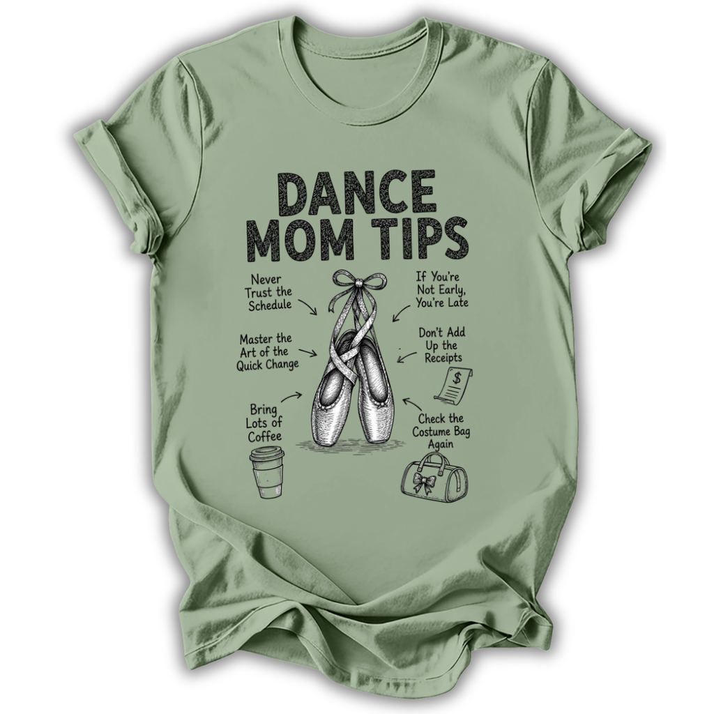 A sage green short-sleeve t-shirt with a black graphic print that reads 'DANCE MOM TIPS' and features illustrations of ballet shoes, a coffee cup, and a shopping bag with humorous dance-related phrases.