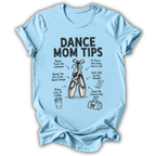 A light blue short-sleeve t-shirt with a black graphic print titled 'DANCE MOM TIPS' featuring illustrations of ballet pointe shoes, a coffee cup, a suitcase, and handwritten dance-related tips, shown on a plain white background.
