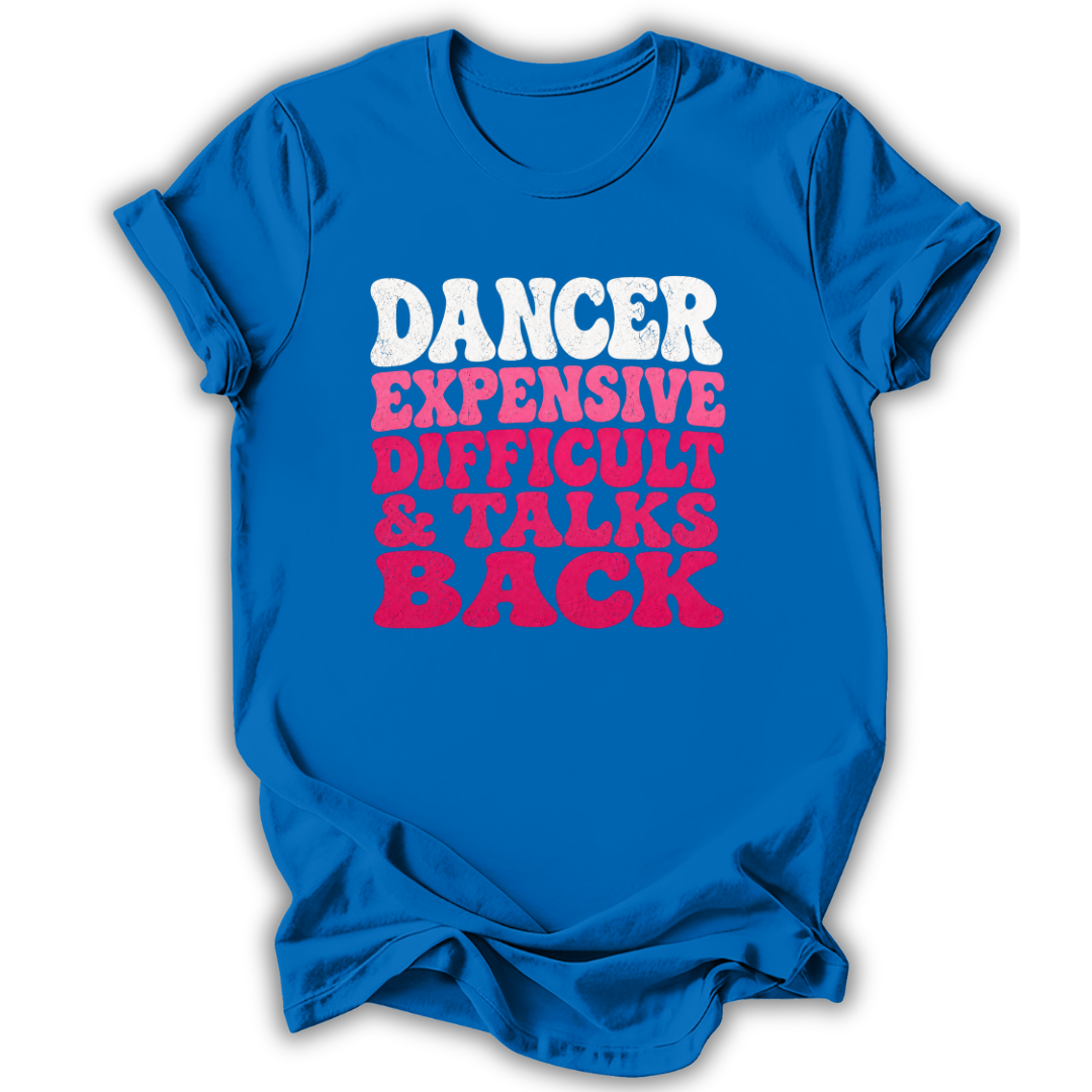 A bright blue short-sleeve t-shirt with a distressed text graphic on the front reading 'DANCER EXPENSIVE DIFFICULT & TALKS BACK' in white and pink lettering, shown on a white background.