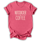 A heather pink short-sleeve t-shirt with the text 'NUTCRACKER & COFFEE' printed in a light pinkish-beige font on the chest, displayed on a clean white background.
