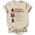A beige short-sleeve crewneck t-shirt featuring a personalized Christmas graphic. The design shows a nutcracker soldier on the left, with the text 'Clara's Christmas Eve' in red and green script, followed by a printed poem in black.